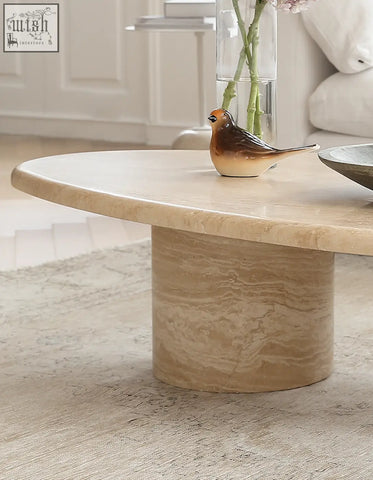 Beige marble clio art deco coffee table with smooth curves oval top and cylindrical base for stylish living room use