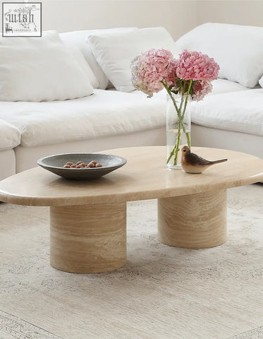 Beige stone clio art deco coffee table with smooth curves oval marble top and two cylindrical legs