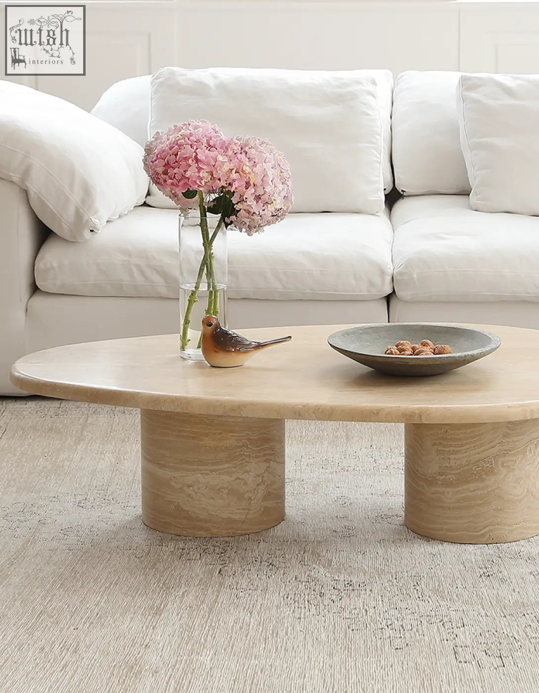 Beige marble coffee table clio art deco with smooth curves and oval top supported by two cylindrical legs