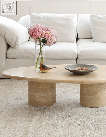 Beige marble coffee table clio art deco with smooth curves and oval top supported by two cylindrical legs