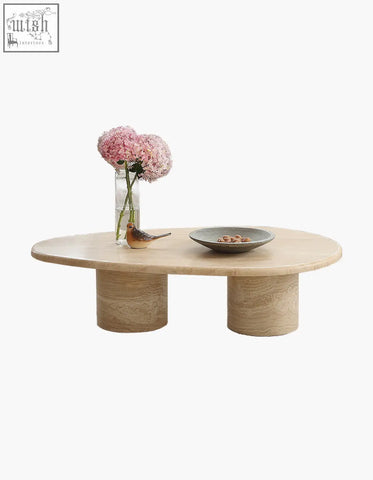 Minimalist clio art deco coffee table with smooth curves oval marble top and matching beige stone cylindrical legs
