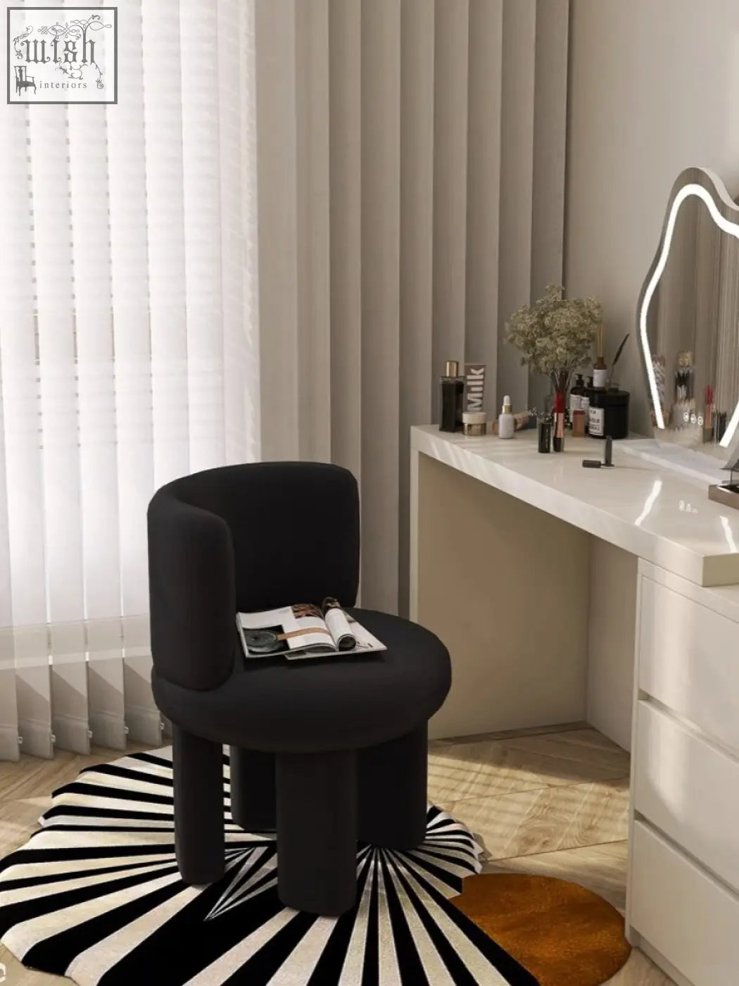 Black upholstered cloud dressing stool with rounded back and thick cylindrical legs for comfy seating