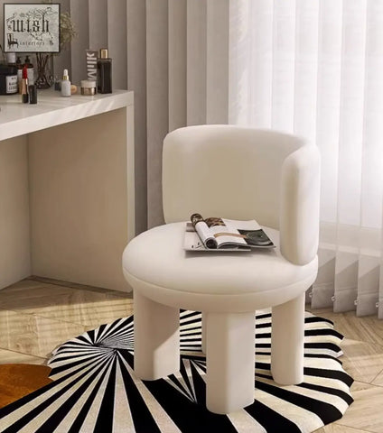 Cream-colored upholstered cloud dressing stool with rounded minimalist design and sturdy cylindrical legs