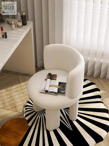 A sleek white upholstered cloud dressing stool with rounded contours and tapered legs for comfy seating