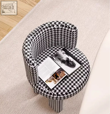 A sleek cloud dressing stool armchair with bold black and white houndstooth upholstery perfect for dressing areas