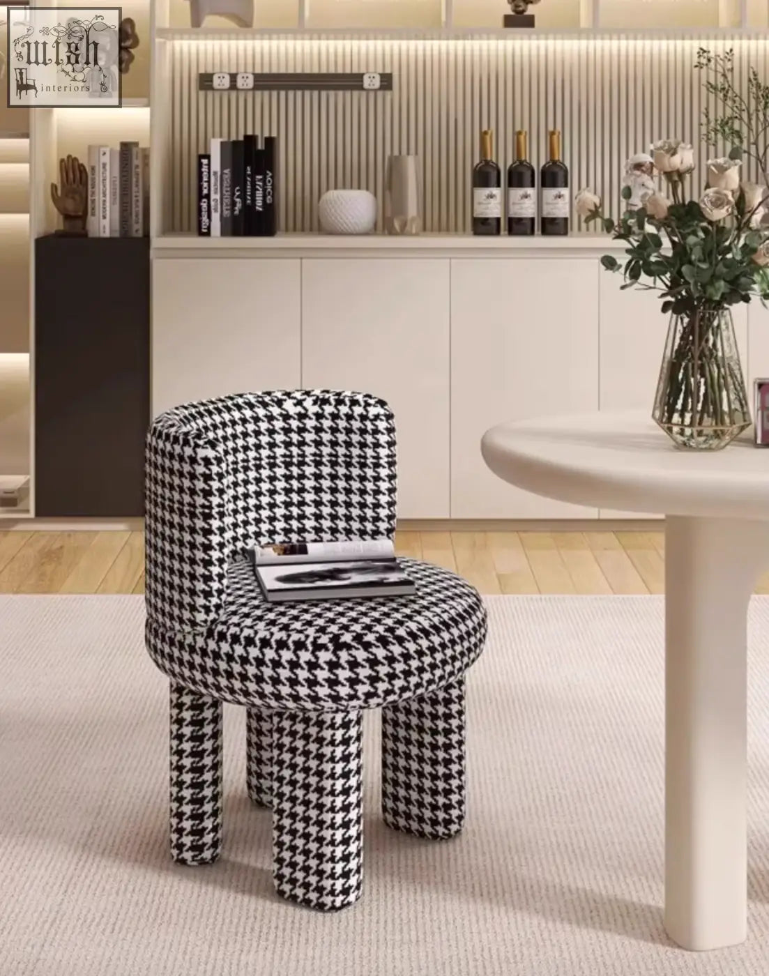 A stylish black and white houndstooth upholstered cloud dressing stool with rounded legs and comfy fabric seat