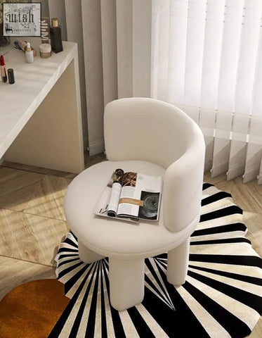 White upholstered cloud dressing stool with rounded minimalist design and tapered legs for dressing room use