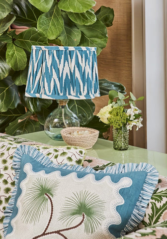 Coastal cabana cushion cover with blue and white ikat pattern and ruffled edges for a beachy vibe