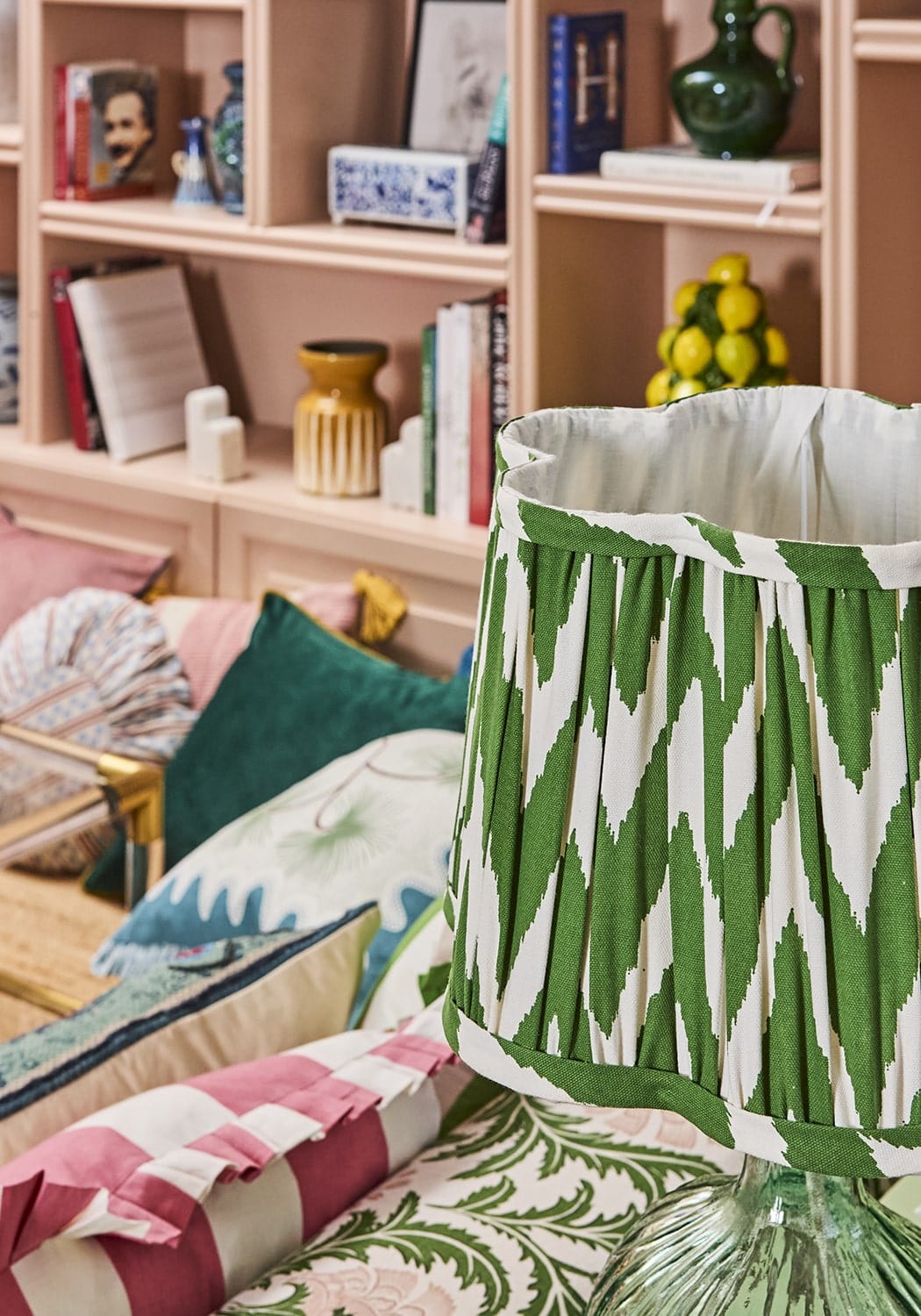 Green and white ikat-patterned pleated lampshade with coastal cabana cushion cover style and vibrant coastal vibe