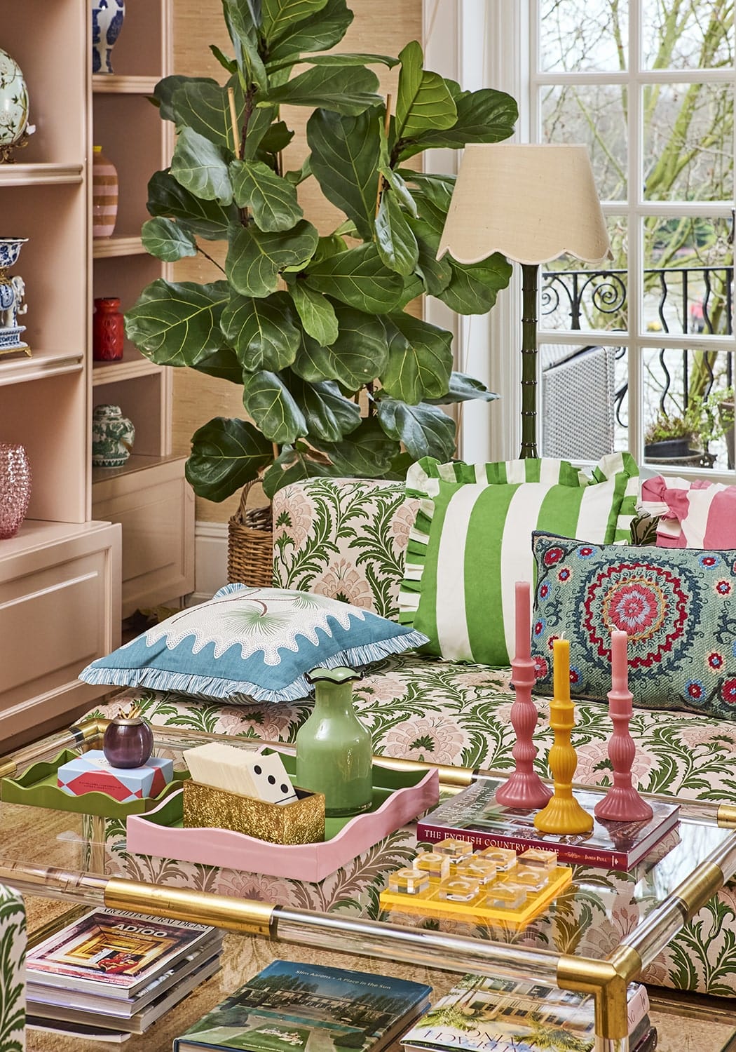Coastal cabana cushion cover with green and white stripes and a decorative patterned accent pillow beside it