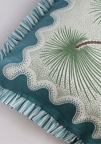 Coastal cabana cushion cover with teal and white palm leaf pattern and ruffled striped trim for beachy vibes