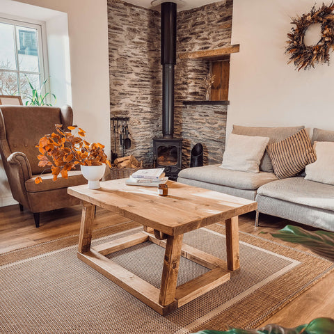 Pictured coav rustic wooden coffee table with sturdy frame and visible grain perfect for living room use