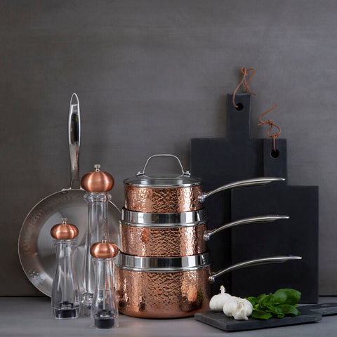 Stacked copper pots with hammered texture and stainless steel rims from cody salt pepper medium clear and copper mill set