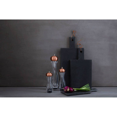 Set of three cody salt pepper medium clear glass mills with copper tops and black bases on dark gray surface
