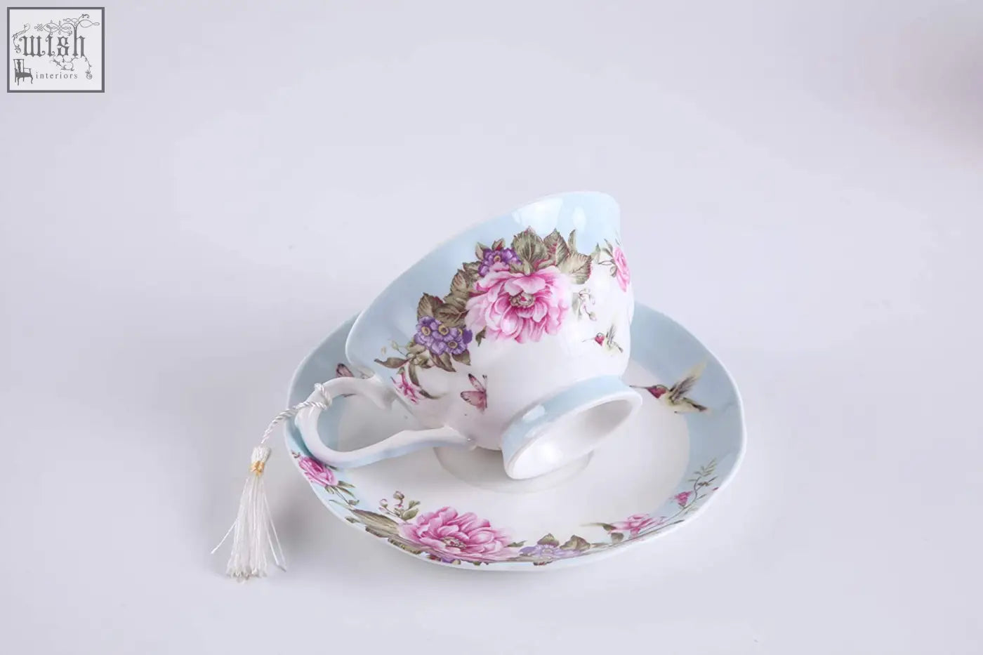 A delicate porcelain coffee tea cup and saucer set with pink peony floral design and blue accents in a gift box dessert plate set