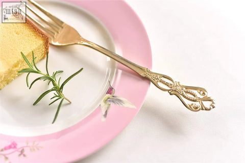Gold fork with ornate filigree handle paired with shabby chic porcelain dessert plate set in pink gift box
