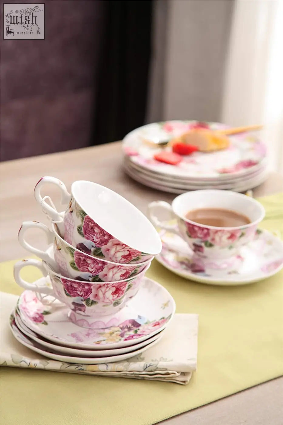 Stack of delicate porcelain coffee tea cup and saucers set with pink bird rose pattern in a gift box