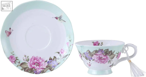 A delicate porcelain coffee tea cup and saucer set with pink roses butterflies in a beautiful gift box