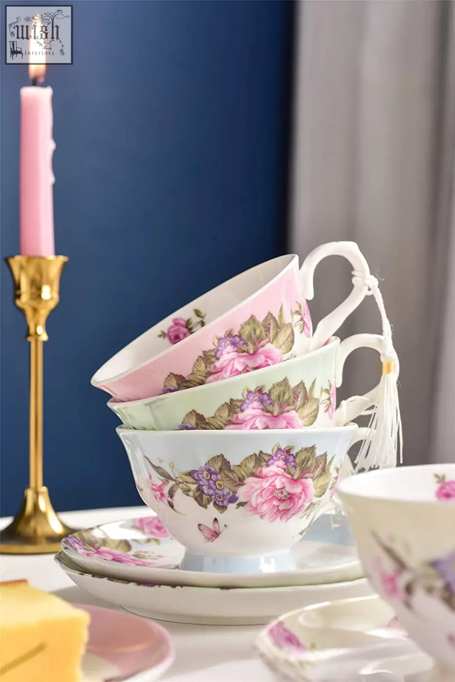 Stacked porcelain coffee tea cups with pink purple floral patterns and curved handles in a beautiful gift box saucers set