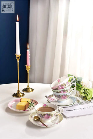 A delicate porcelain coffee tea cup and saucer set with floral pattern and gold rim in a beautiful gift box