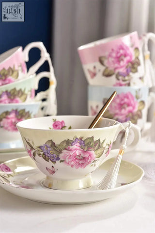 A delicate cream porcelain teacup with pink roses and butterflies in a beautiful gift box saucers set