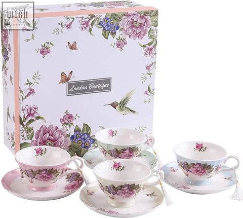 Set of four shabby chic vintage porcelain teacups and saucers set with pink floral patterns in a beautiful gift box