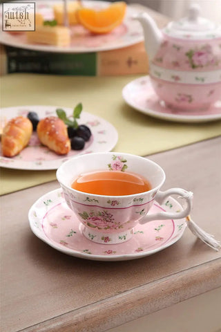 Pink floral porcelain teacup with matching saucer filled with tea in a rose lavender 1pc set gift box