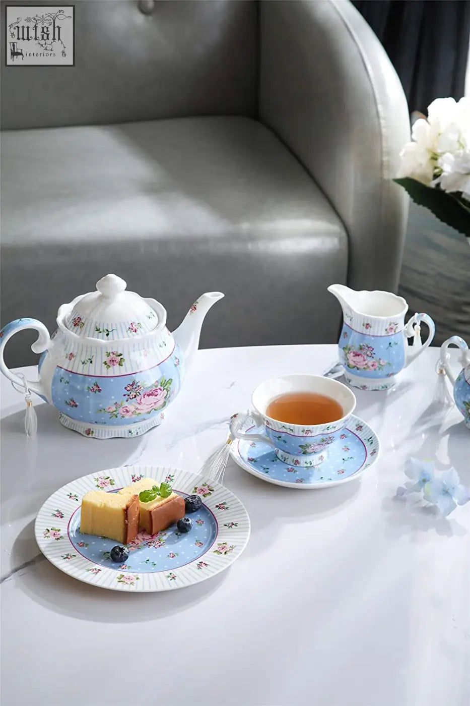 A delicate porcelain teapot with light blue floral pattern white accents in a rose lavender 1pc set gift box