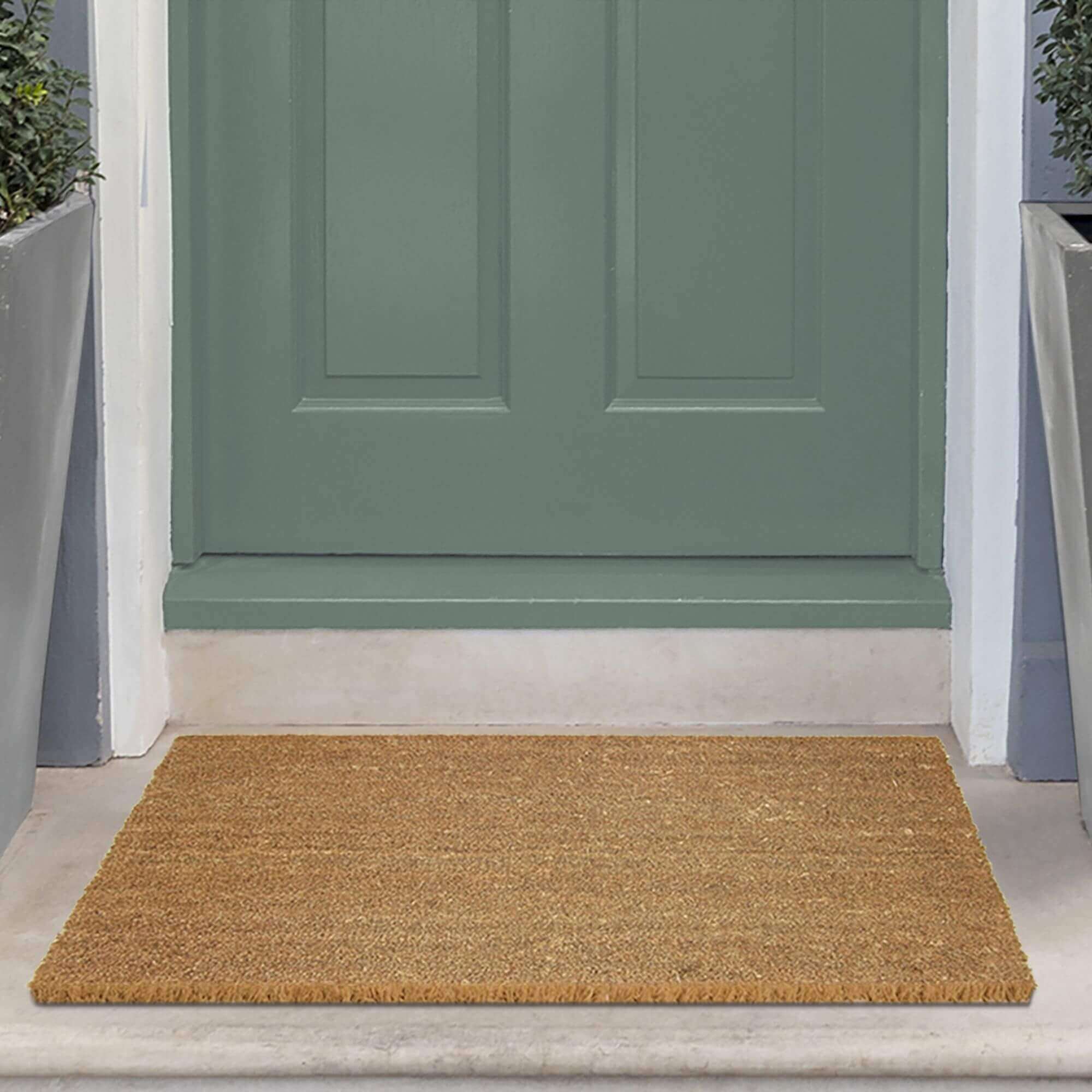 Natural fiber coir solid design mat with light brown textured surface and frayed edges perfect for entryways