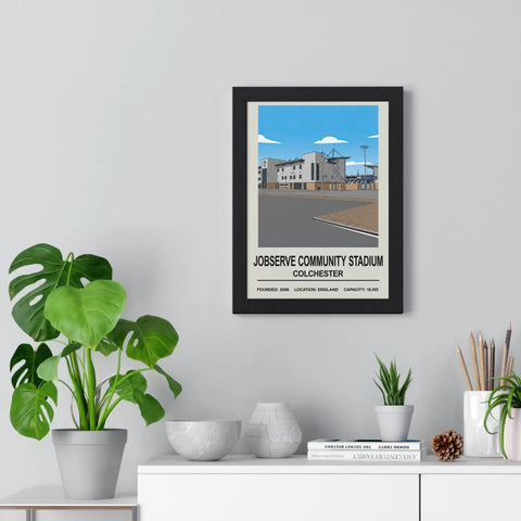 Black-framed poster print of jobserve community stadium in colchester with stylized illustration and text design