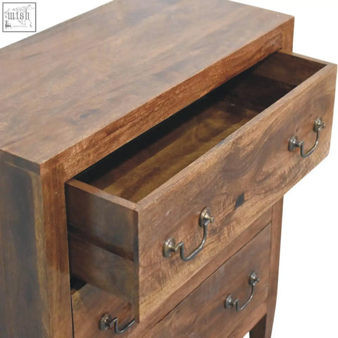 A rustic compact three drawer chest with warm brown wooden finish and vintage metal handles
