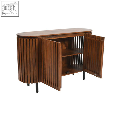 A sleek oval-shaped compton mango wood sideboard with vertical slat doors and black metal legs in solid mango wood