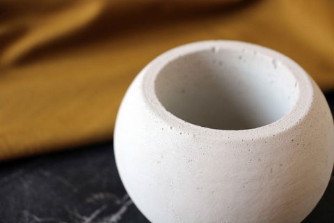 White textured concrete round pot with smooth rounded exterior and slightly rough interior for stylish decor