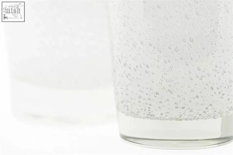 Clear glass conic vase from the dutz collection with thick mouth blown glass and visible bubbles inside