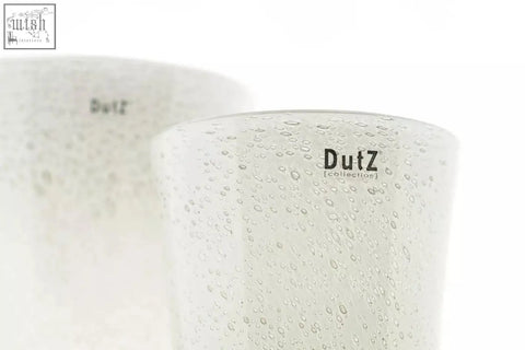A frosted white mouth blown glass tumbler from dutz collection with a textured bubbly surface and dutz logo