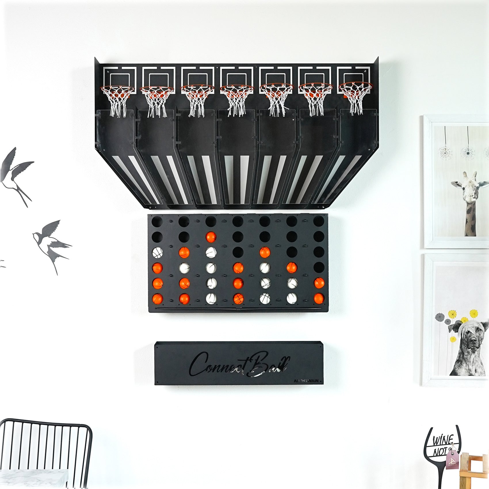Black wall-mounted connect balls arcade game with five hoops and tray holding four balls as central piece