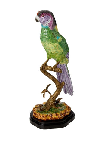 Vibrant green and purple parrot figurine perched on detailed bronze branch with ornate black base copacabana bird decor