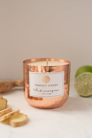 Copper dimpled candle jar with hammered texture and energise lime plus ginger label for refreshing vibes