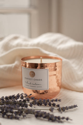 Copper dimpled candle jar with hammered texture white wax and perfect chaos label for relaxation use