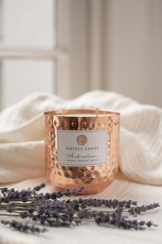 Copper dimpled candle jar with hammered texture labeled perfect chaos by andrela with lavender and rosewood scents