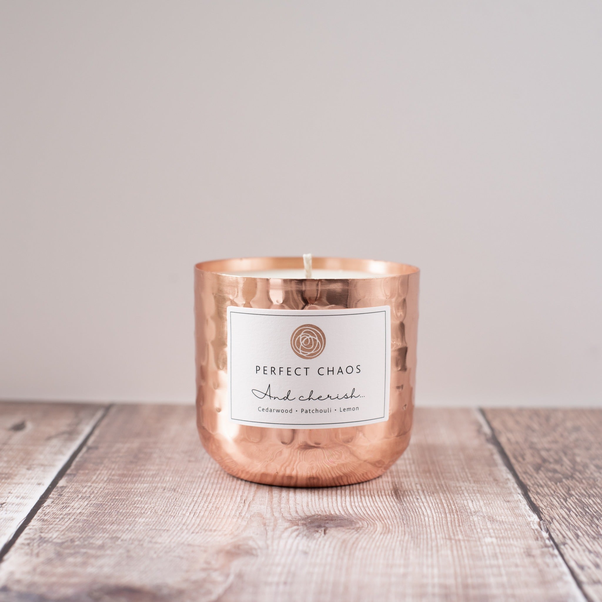Copper pot refill with copper hammered candle jar labeled perfect chaos featuring cedarwood patchouli and lemon scent notes