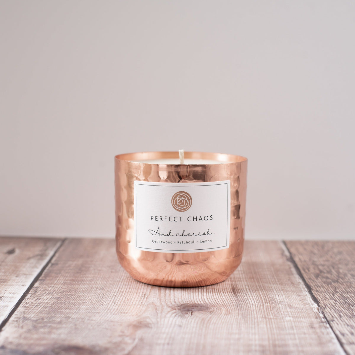 Copper pot refill with copper hammered candle jar labeled perfect chaos featuring cedarwood patchouli and lemon scent notes