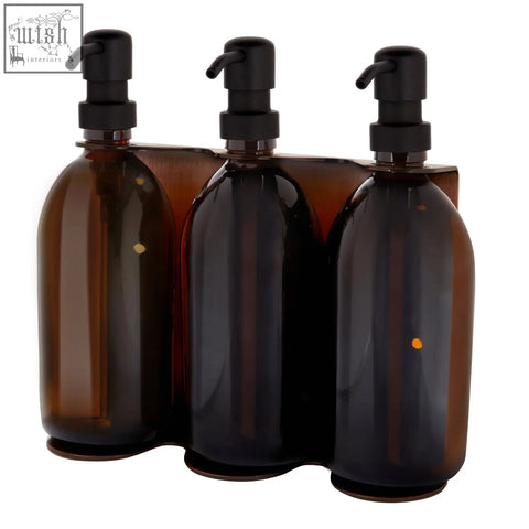 Set of three copper triple wall-mounted amber glass soap dispensers with black pump tops for easy use