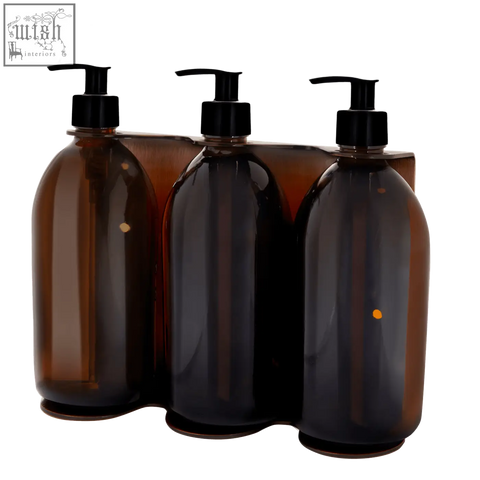 Set of three amber glass soap dispensers with black pumps designed as a copper triple wall mounted soap dispenser