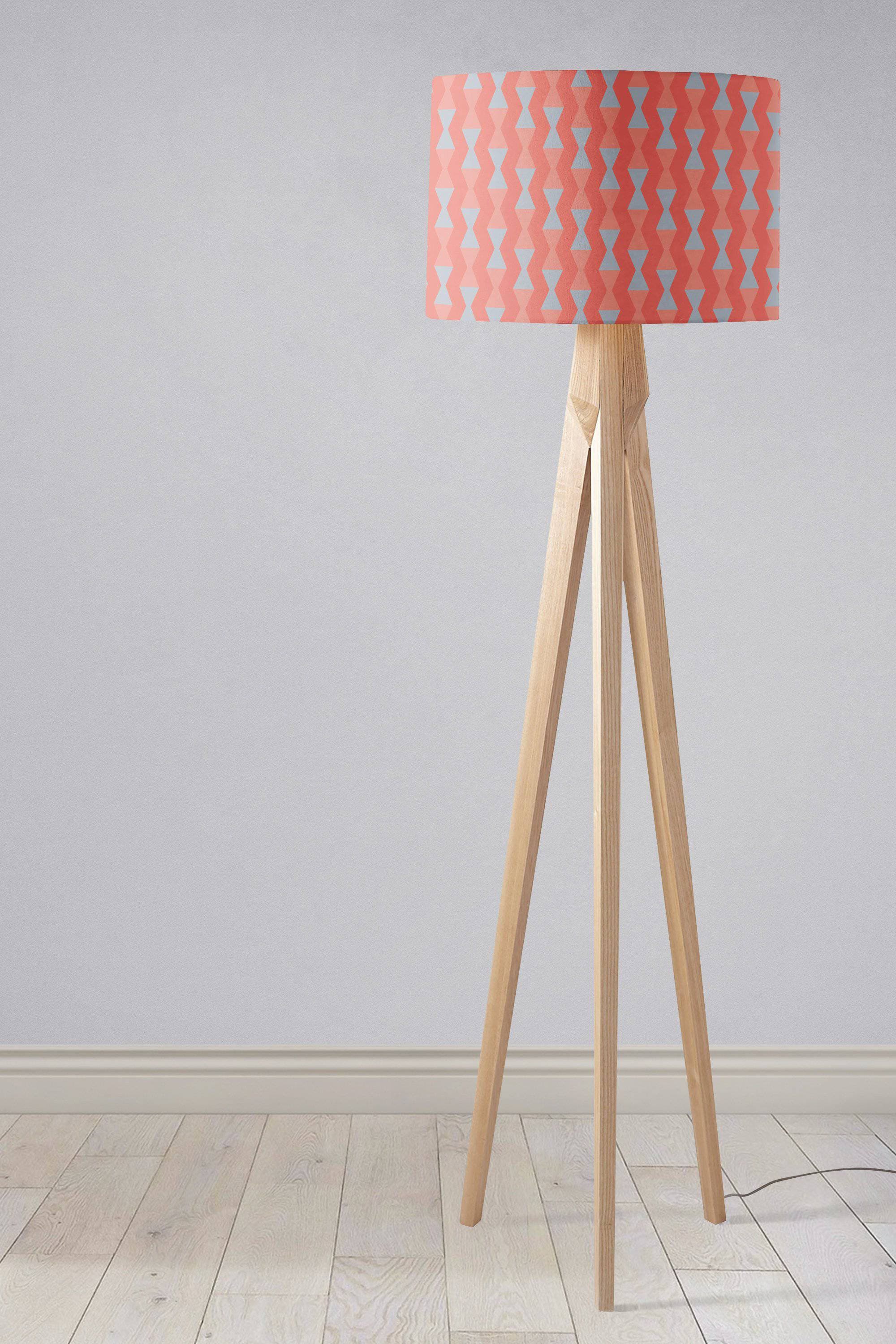 Coral and grey mid century modern retro table lamp with coral lampshade and light blue bow pattern on wooden tripod base