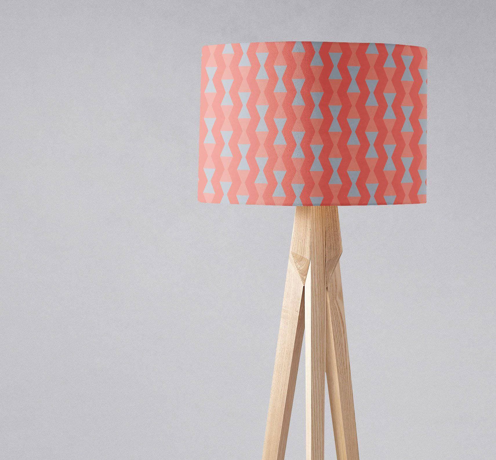Coral and grey mid century modern retro table lamp with a coral and light blue geometric lampshade on wooden tripod base with inch diameter
