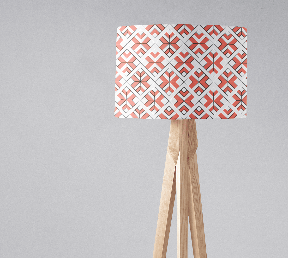 Coral and white geometric design lampshade on a light wooden tripod base perfect for a table lamp or ceiling light