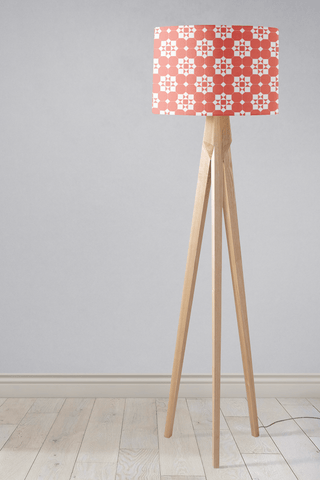 Coral and white geometric design lampshade on a wooden tripod base perfect for a stylish table lamp