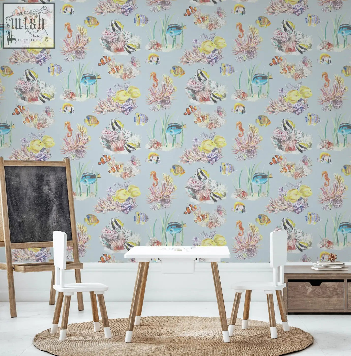 A charming children’s room with vibrant light blue coral reef watercolour wallpaper featuring colorful tropical fish