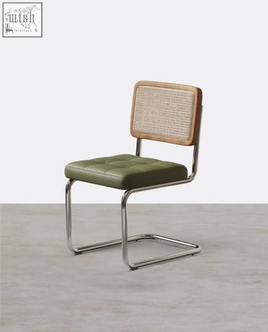 Olive green tufted leather cornelia dining chair with woven cane backrest and chrome cantilever legs in light wood frame